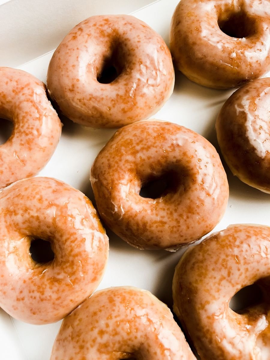 Glazed donuts fresh from the fryer